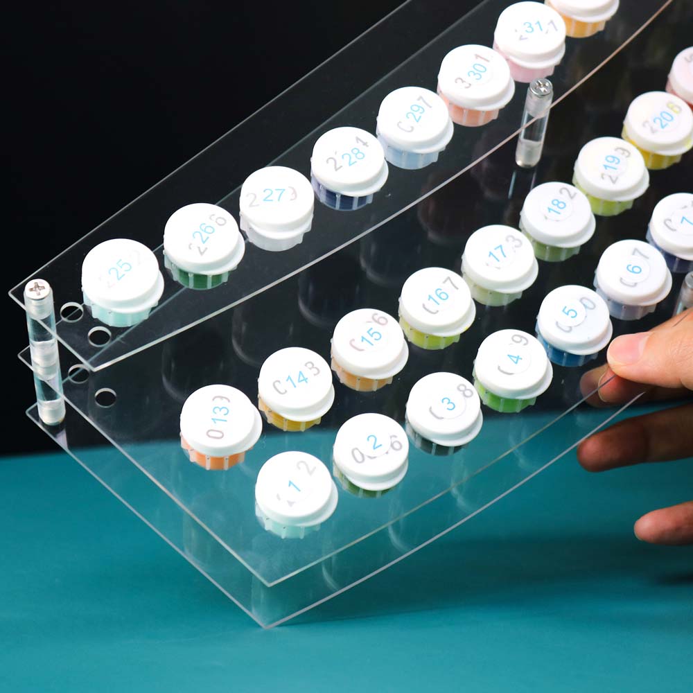 Clear organizer with labeled small containers on a blue surface
