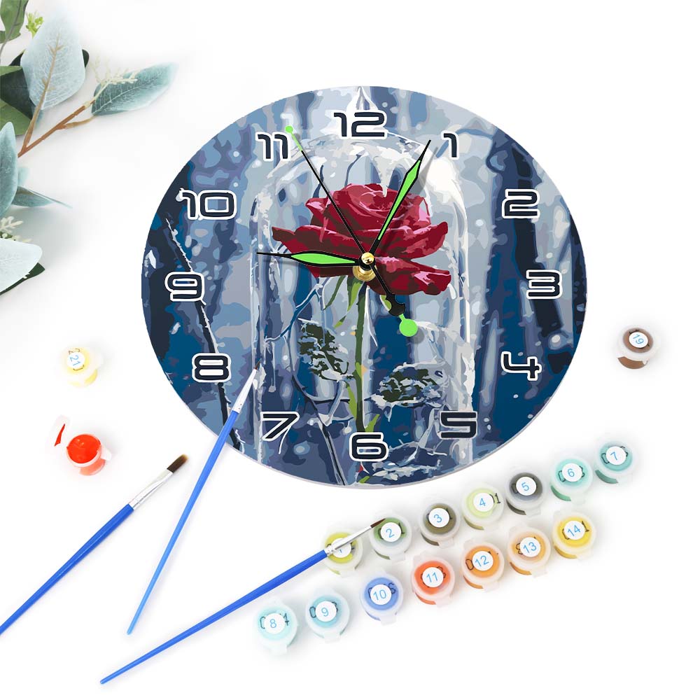 Decorative clock with a rose design, surrounded by paint cans and brushes on a white background