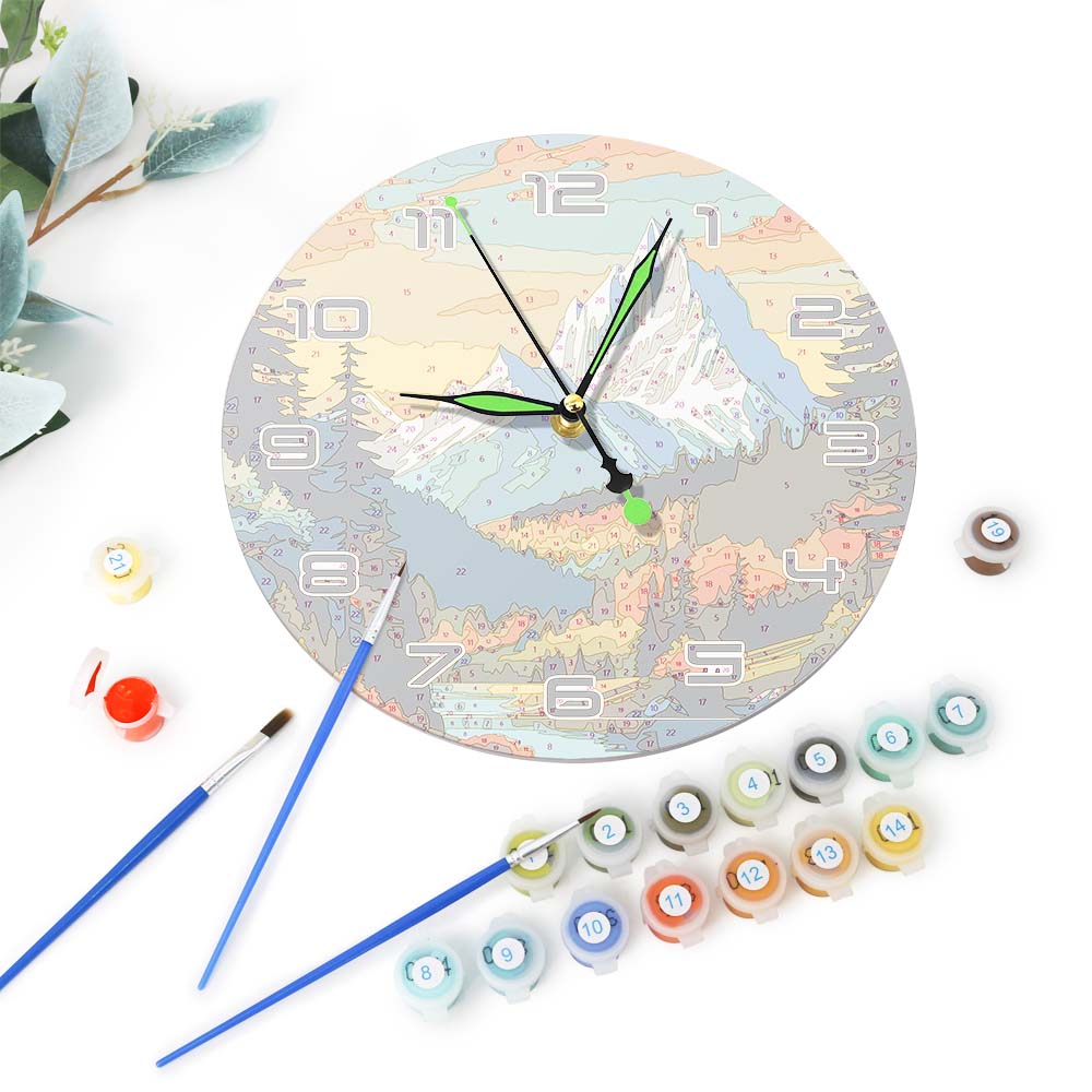 Decorative clock with paint supplies on a white background
