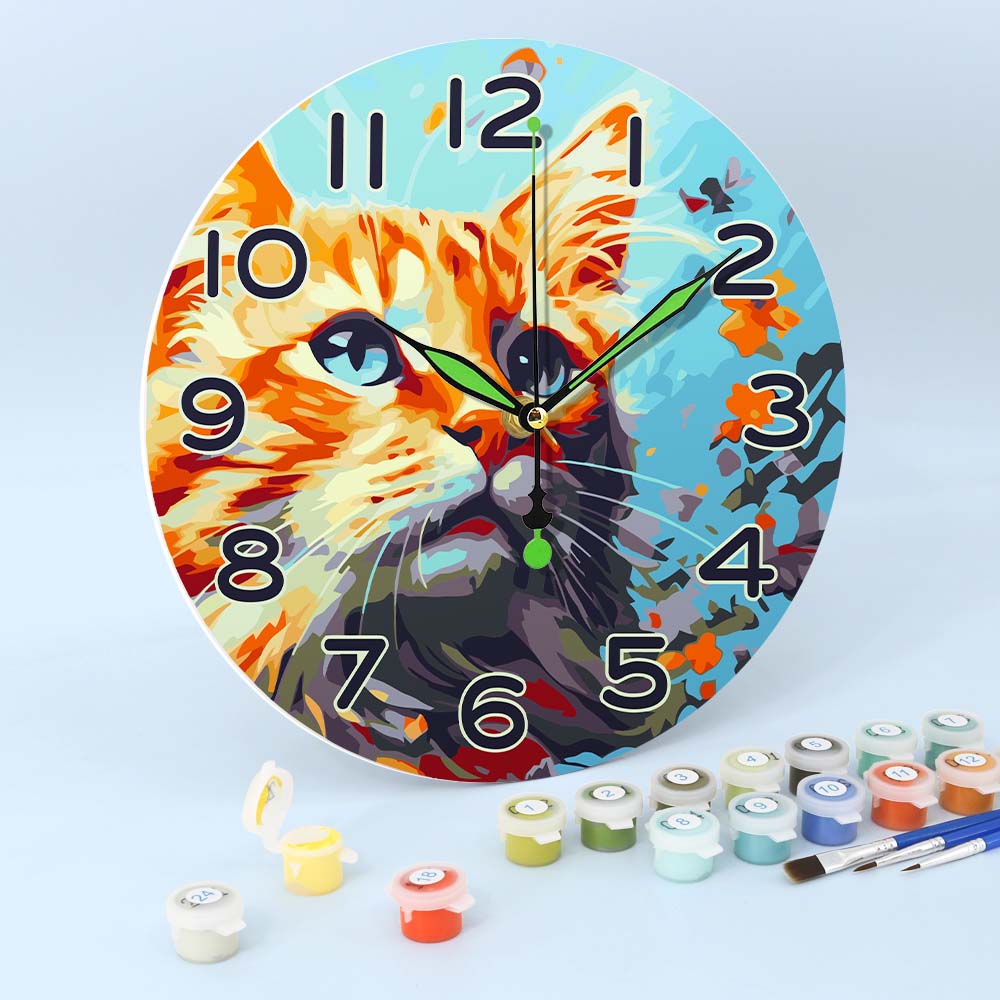 Wall clock with a cat design on a light blue background, surrounded by paint cans and brushes.