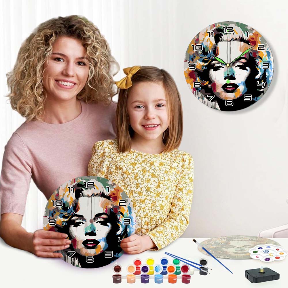 Woman and child holding painted wall clocks with colorful designs, surrounded by art supplies.
