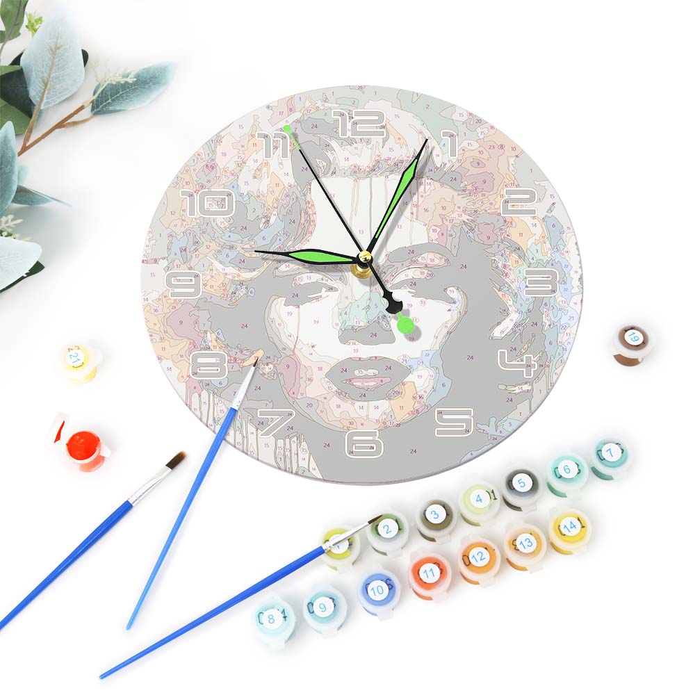 Decorative wall clock with paint bottles and brushes on a white background