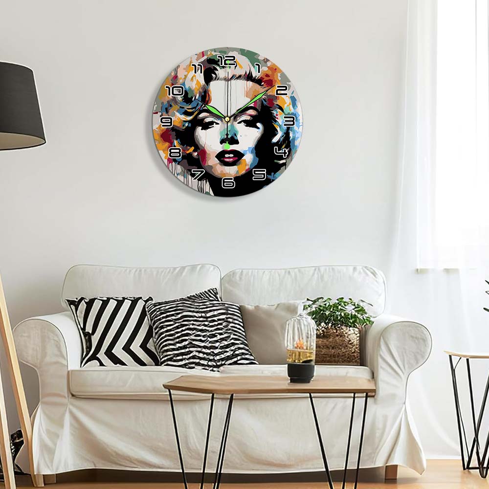 Decorative wall clock with artistic design on a white wall above a sofa.