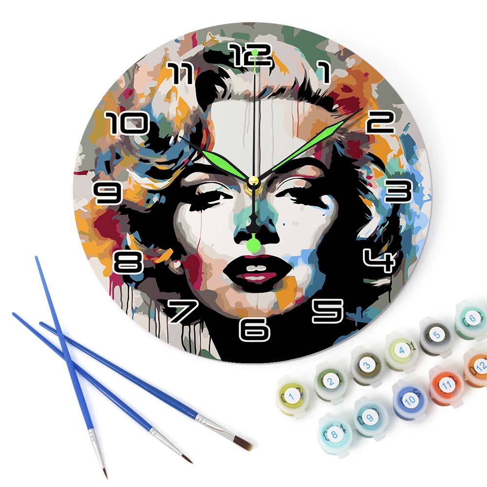 Decorative wall clock with artistic design, paintbrushes, and paint cans on a white background