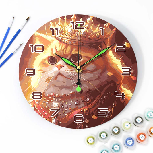 Wall clock with a cat design surrounded by art supplies on a white background