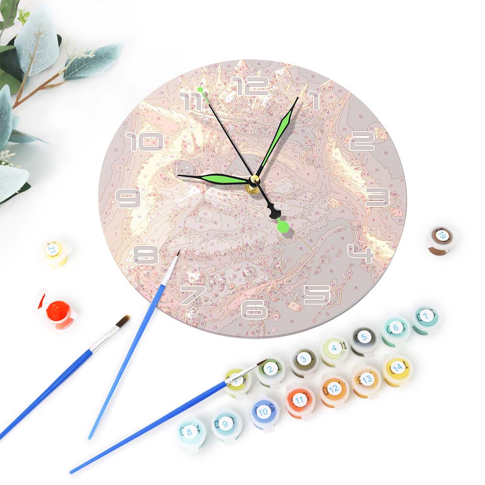 Decorative wall clock with paint bottles and brushes on a white background