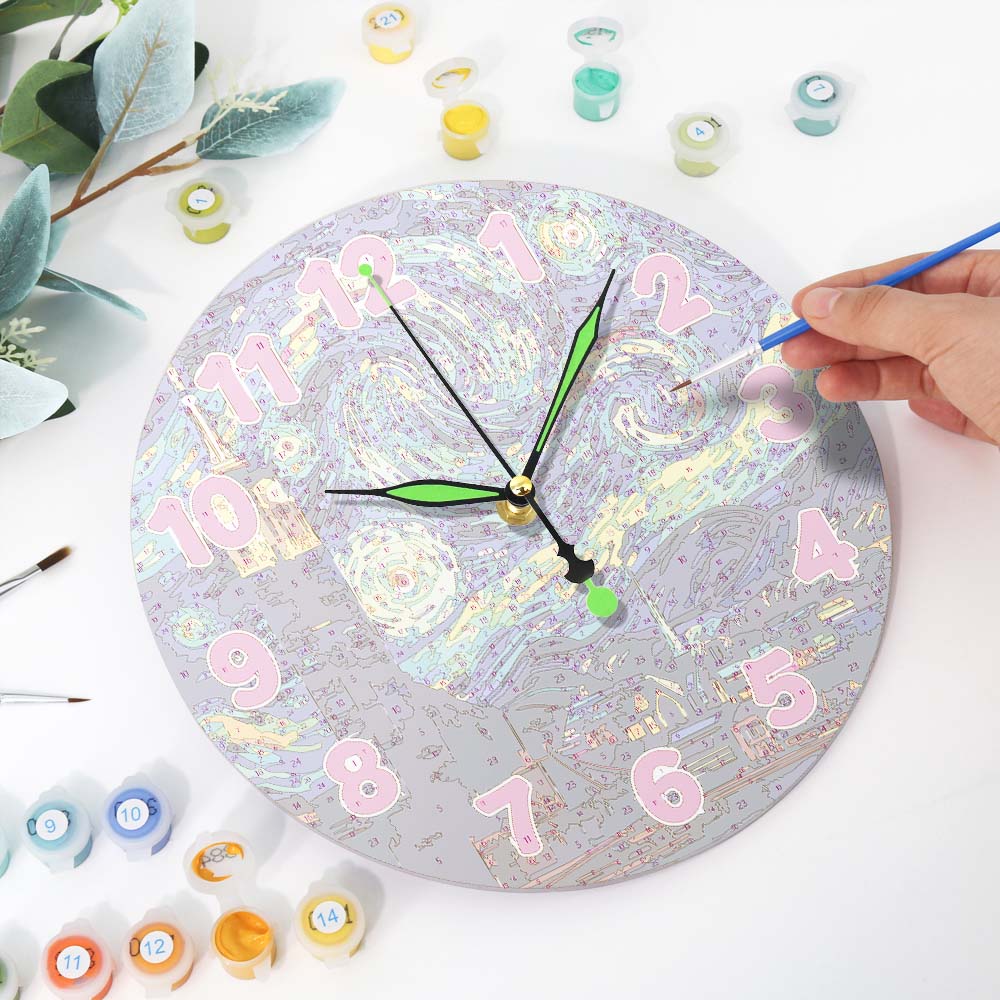 Person painting a clock with colorful numbers and designs on a white surface.