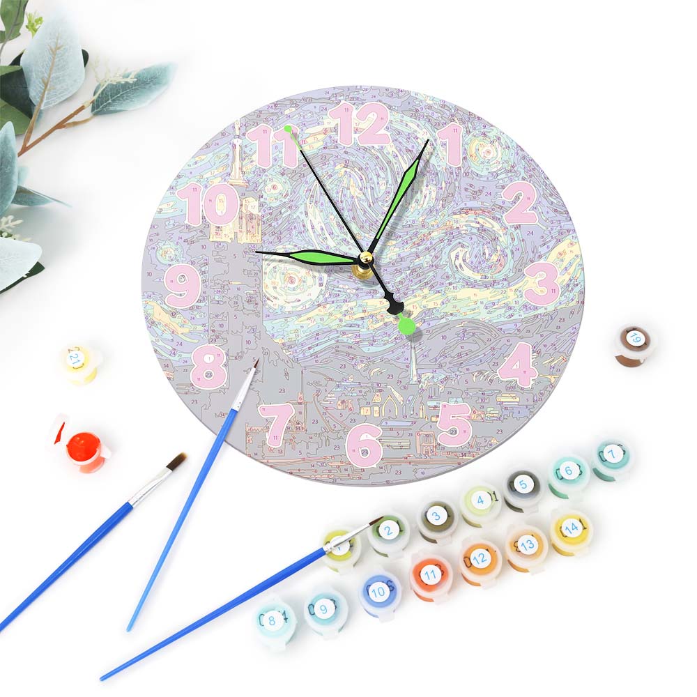 Decorative clock with colorful numbers and paint supplies on a white background