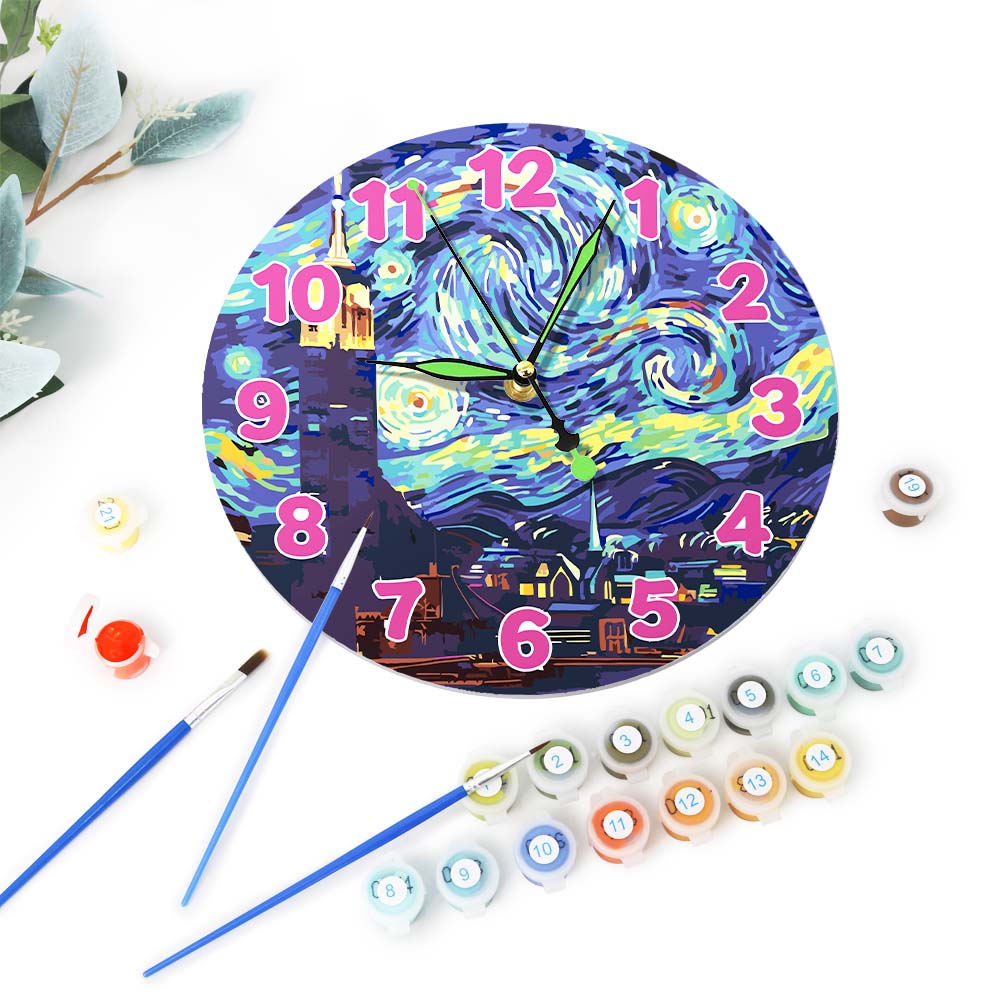 Decorative clock with artistic design, surrounded by paint bottles and brushes on a white background