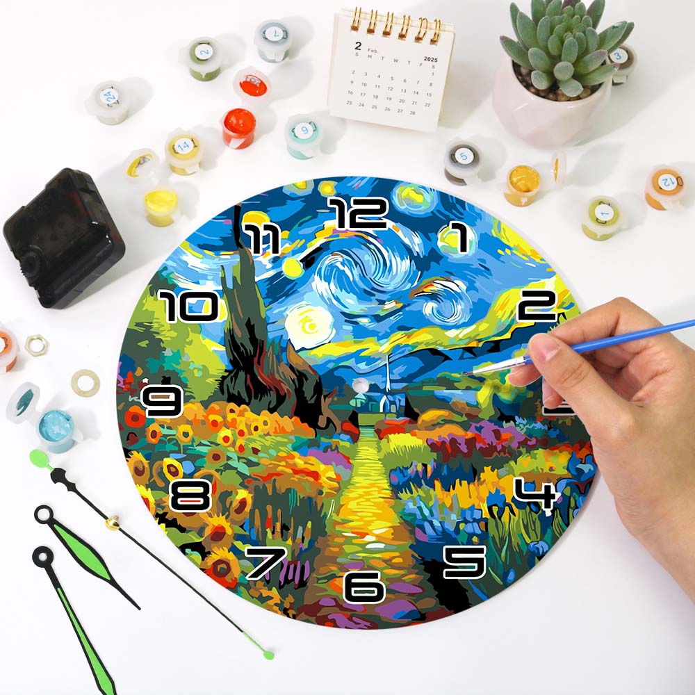 Colorful clock with artistic design, surrounded by art supplies on a white surface.