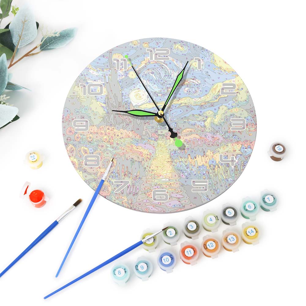 Decorative clock with paint bottles and brushes on a white background
