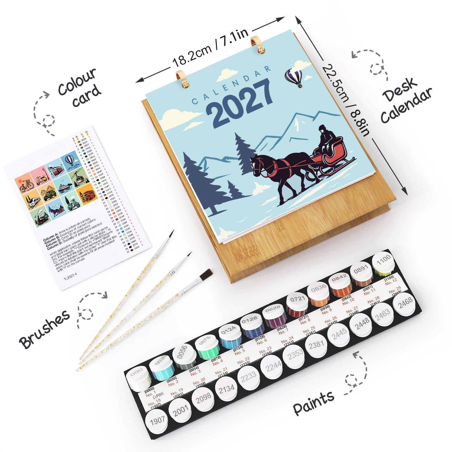A 2027 desk calendar set shown on a white background with dimension arrows and labels. The set includes a wooden-framed calendar with a winter horse-drawn carriage illustration, a colour card sheet, two paintbrushes, and a tray of small round paint pots.