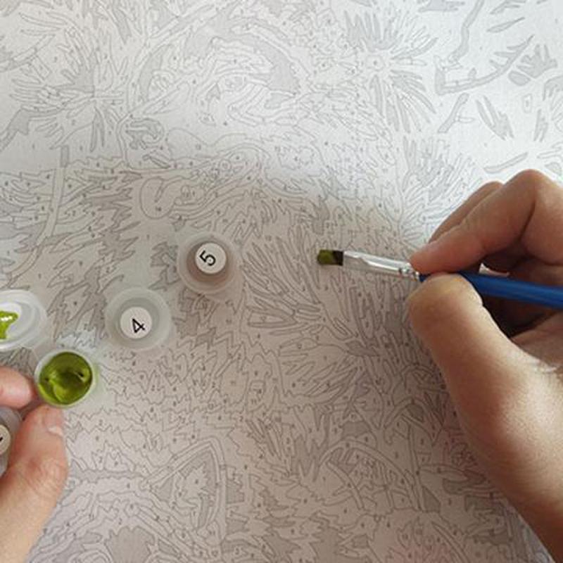 Paint by Numbers canvas with detailed numbered sections and color-coded acrylic paints. A hand painting a pet portrait, making it easy for beginners to follow and enjoy a relaxing artistic experience.
