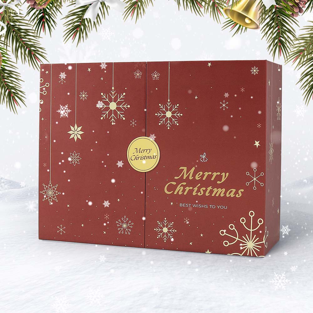 Red Christmas gift box with gold snowflakes and 'Merry Christmas' text on a snowy background.