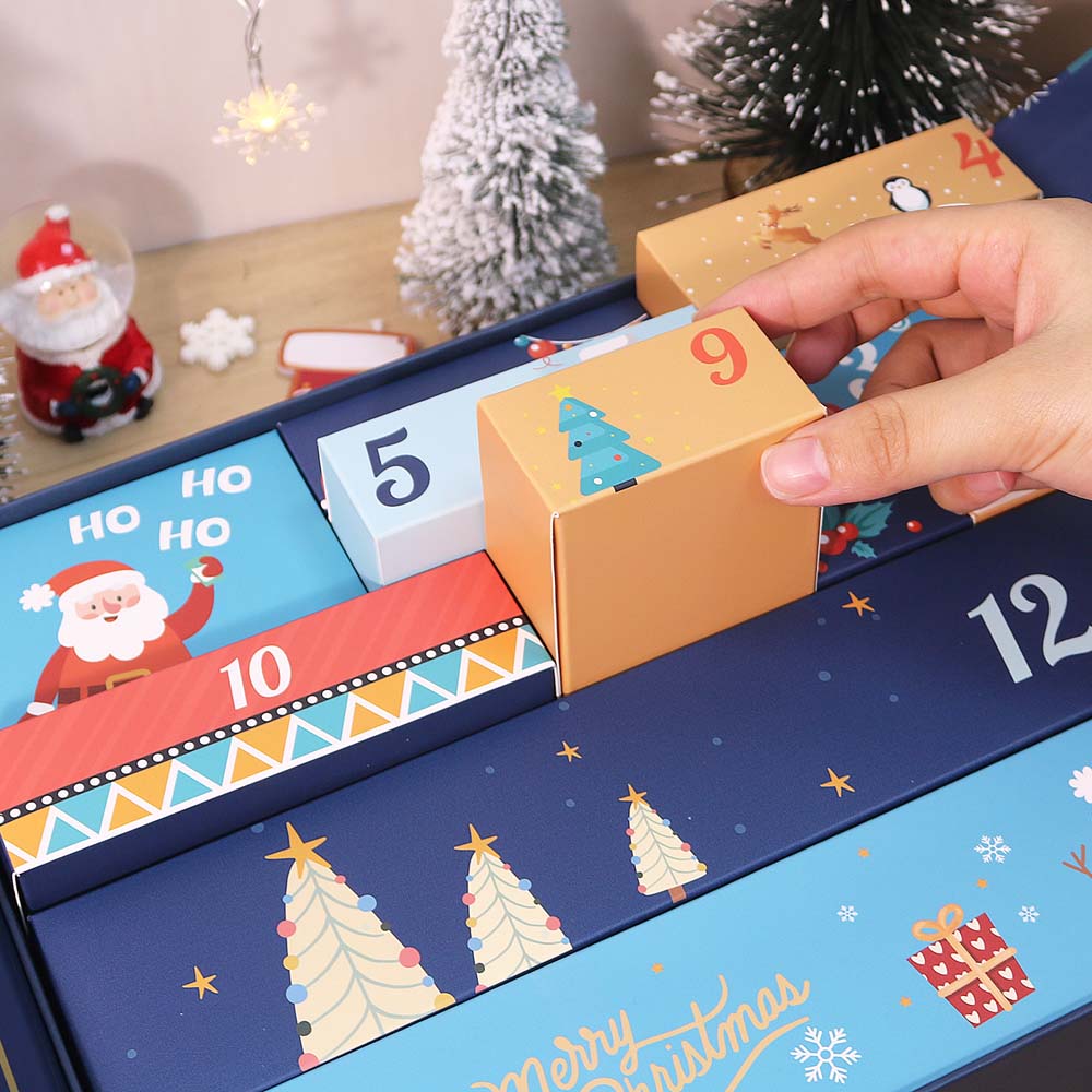 Hand opening a Christmas advent calendar with festive designs and numbers.