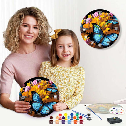 Woman and child holding butterfly-themed wall clocks with painting supplies on a table.