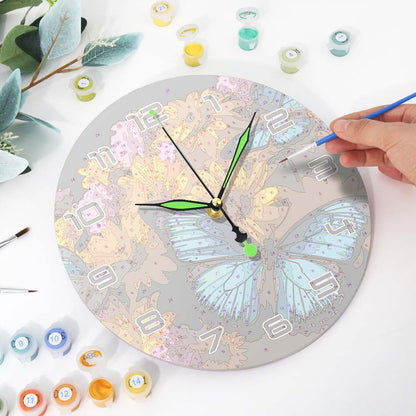 Person painting a butterfly design on a round clock with various paint containers and brushes around.