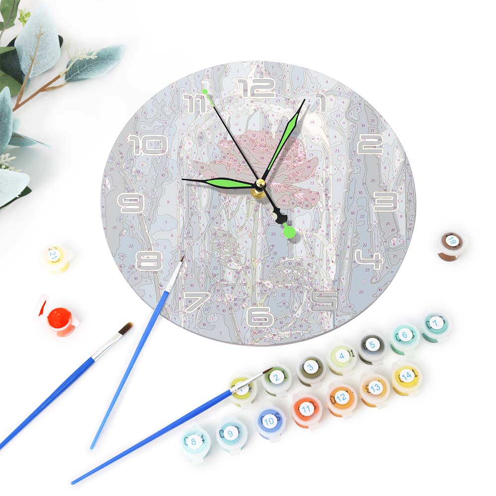 
Decorative wall clock with paint bottles and brushes on a white background