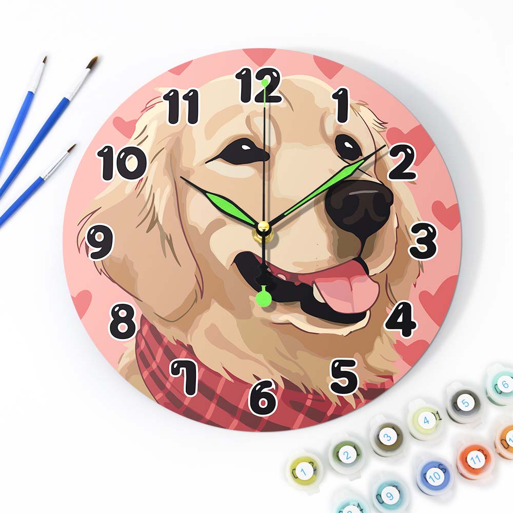 
Wall clock with a dog design on a pink background, surrounded by art supplies.