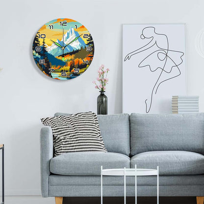 Living room with a gray sofa, decorative pillow, and wall clock featuring a mountain landscape.