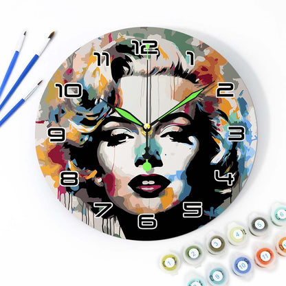 Colorful wall clock with artistic design of a face, surrounded by art supplies.