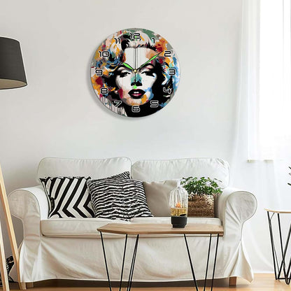 Decorative wall clock with artistic design on a white wall above a sofa.