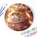 Wall clock with a cat design surrounded by art supplies on a white background