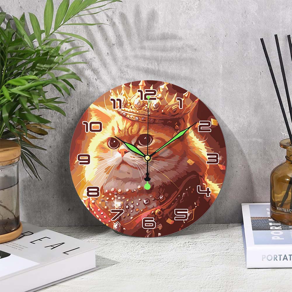 
Wall clock with a cat design on a gray wall with a plant and books in the background